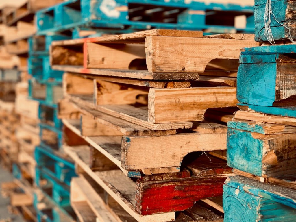 pexels photo 1684989 Close-up of colorful stacked wooden pallets in outdoor sunlight.
